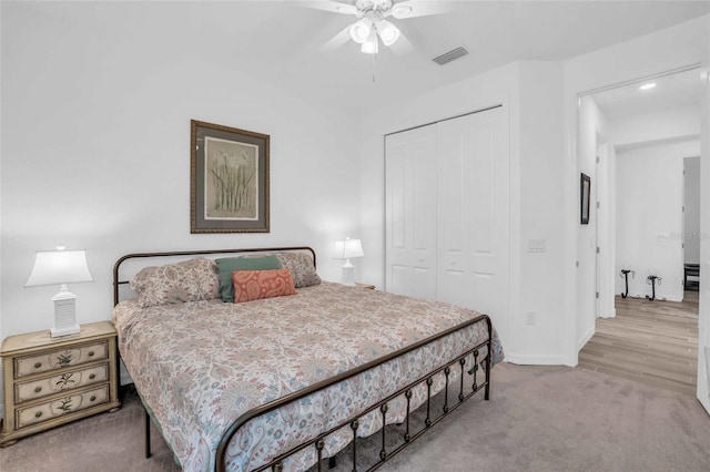 carpeted bedroom featuring a closet, visible vents, ceiling fan, and baseboards