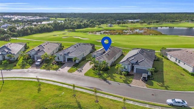 aerial view featuring a residential view, a water view, and golf course view