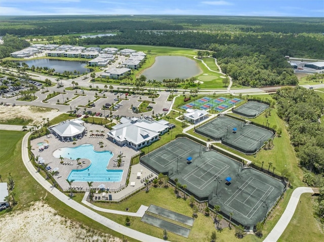 aerial view with a forest view and a water view