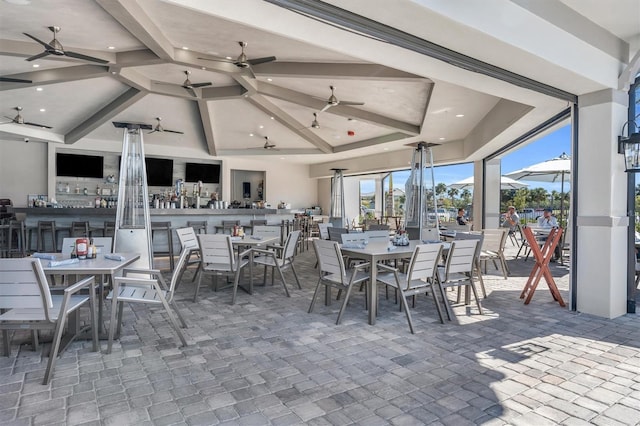 view of patio with outdoor dining area and a ceiling fan