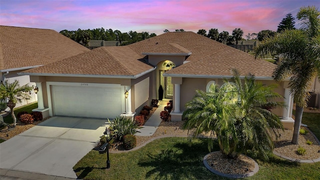 24588 Buckingham Way, Port Charlotte, FL 33980 - single story home featuring a garage, a shingled roof, concrete driveway, and stucco siding