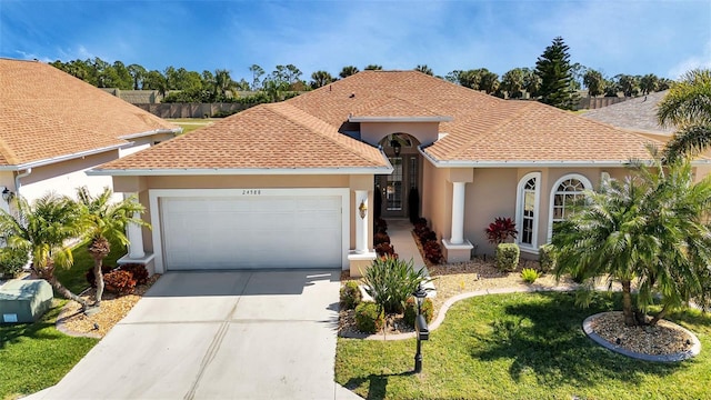 24588 Buckingham Way, Port Charlotte, FL 33980 - view of front of house featuring concrete driveway, an attached garage, a shingled roof, a front yard, and stucco siding