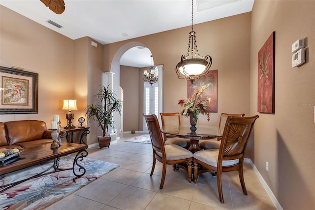 tiled dining area with a notable chandelier