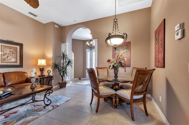 24588 Buckingham Way, Port Charlotte, FL 33980 - dining area featuring baseboards, visible vents, arched walkways, and light tile patterned floors