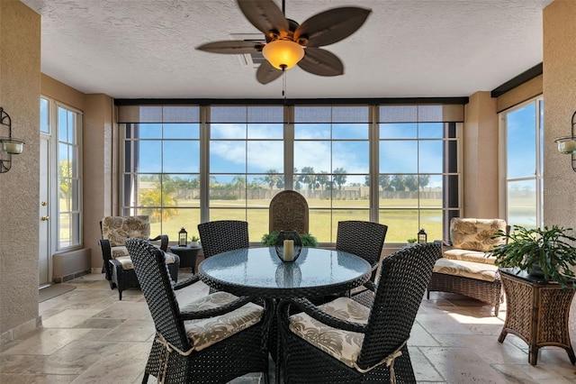 sunroom / solarium with a wealth of natural light and ceiling fan