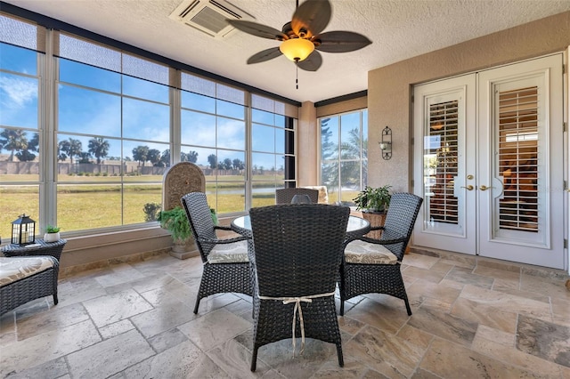 sunroom with ceiling fan and french doors