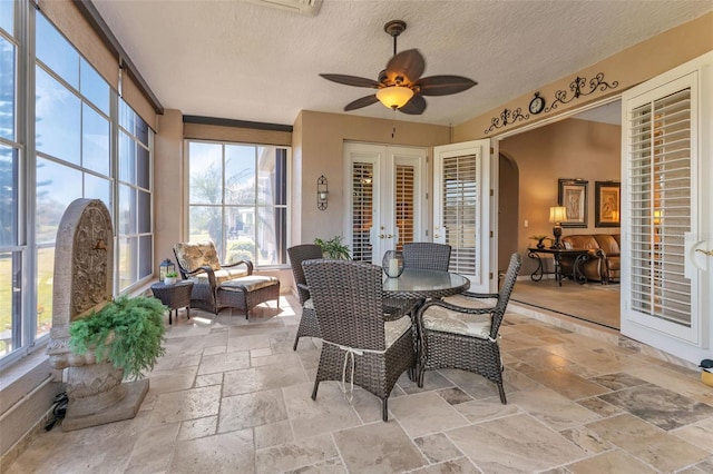 sunroom with french doors, a healthy amount of sunlight, and ceiling fan