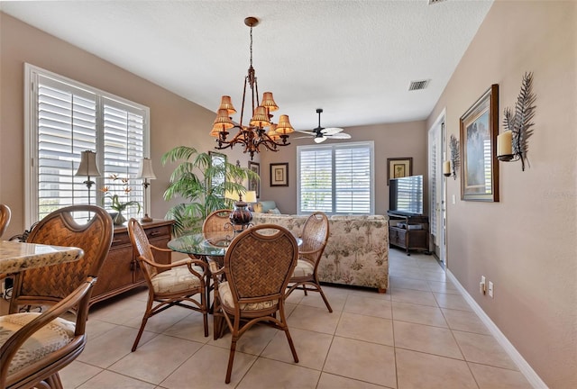 24588 Buckingham Way, Port Charlotte, FL 33980 - dining room featuring a textured ceiling, baseboards, visible vents, a chandelier, and light tile patterned floors