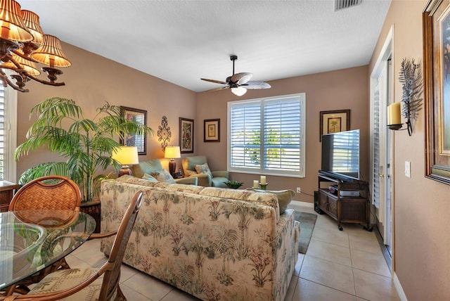 tiled living room with a textured ceiling and ceiling fan