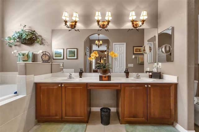 24588 Buckingham Way, Port Charlotte, FL 33980 - bathroom featuring an inviting chandelier, double vanity, a garden tub, and a sink