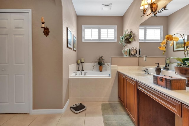 bathroom with plenty of natural light, tiled bath, vanity, and tile patterned flooring