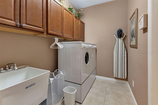 clothes washing area featuring separate washer and dryer, light tile patterned floors, cabinets, and sink