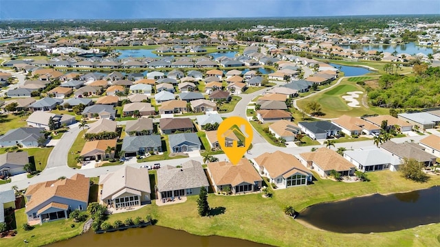 birds eye view of property with a water view