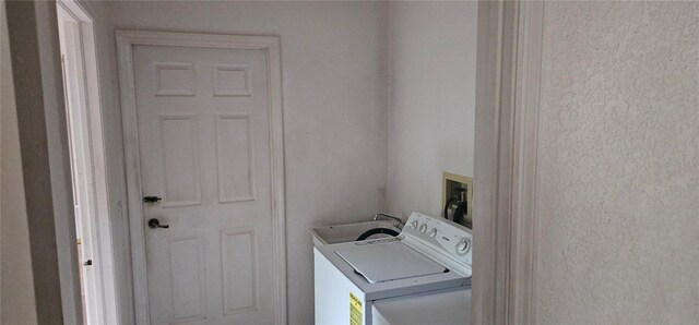 clothes washing area with laundry area and washer and dryer