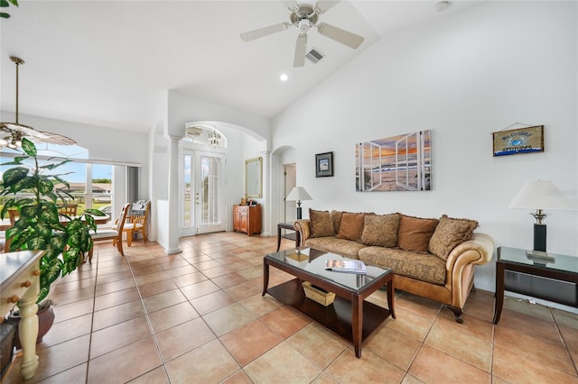 tiled living room with high vaulted ceiling and ceiling fan