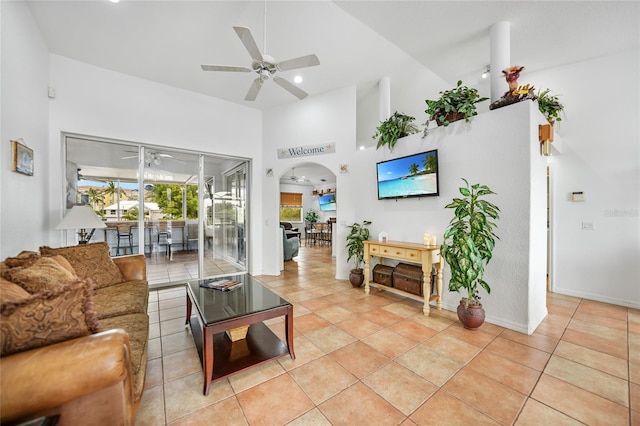 tiled living room with high vaulted ceiling and ceiling fan