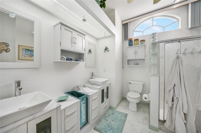 bathroom with toilet, an enclosed shower, vanity, a textured ceiling, and ceiling fan