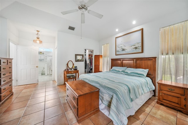 tiled bedroom with a spacious closet, ceiling fan, a closet, and ensuite bathroom