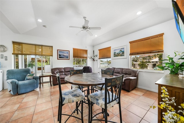 dining space featuring a healthy amount of sunlight, ceiling fan, vaulted ceiling, and light tile patterned flooring