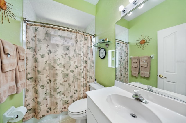 bathroom featuring tile patterned flooring, vanity, toilet, and curtained shower