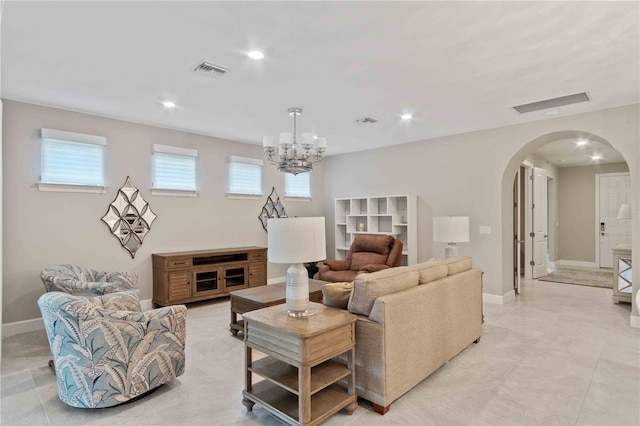 living area with visible vents, arched walkways, baseboards, and recessed lighting