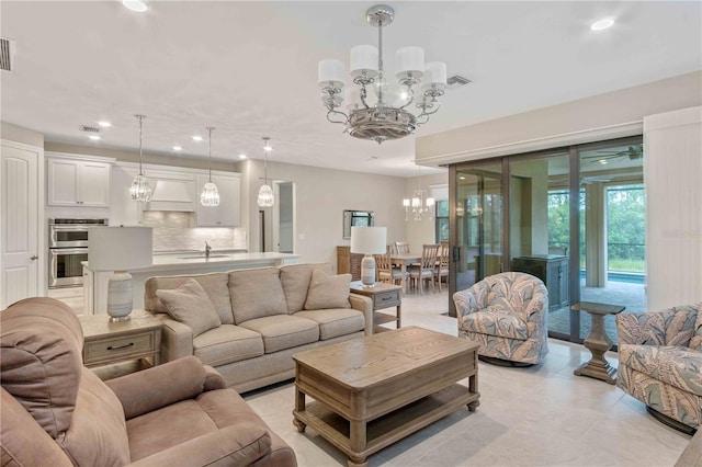 living room featuring recessed lighting, visible vents, a notable chandelier, and light tile patterned floors