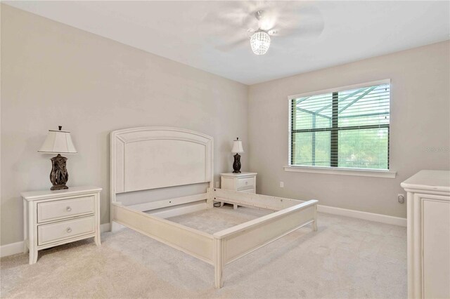 bedroom featuring ceiling fan and light carpet