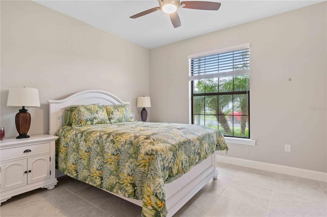 bedroom featuring light tile patterned flooring, ceiling fan, and baseboards