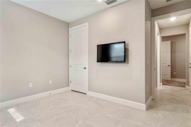 interior space featuring baseboards and visible vents