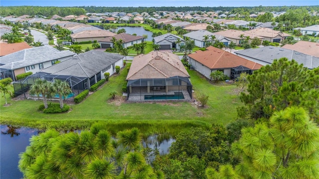 drone / aerial view featuring a water view and a residential view