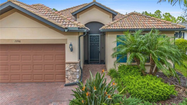 mediterranean / spanish house with a garage