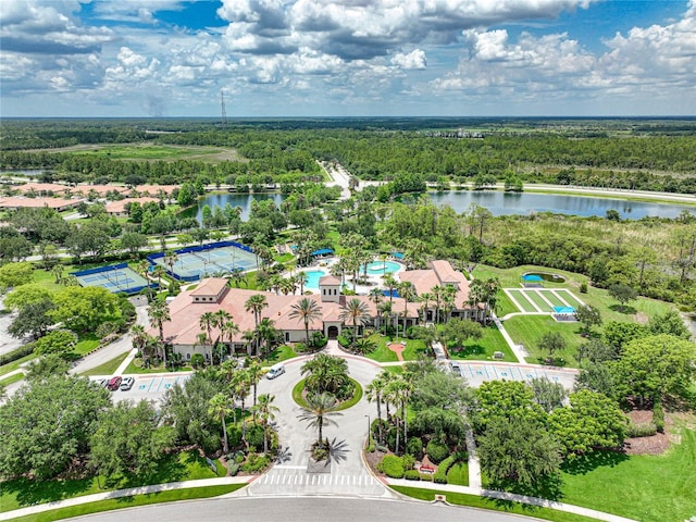 aerial view with a water view and a wooded view