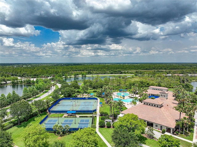 birds eye view of property featuring a forest view and a water view