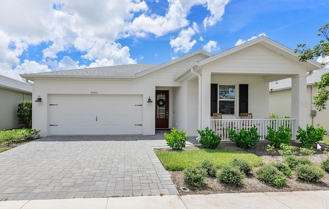 single story home with a garage and covered porch