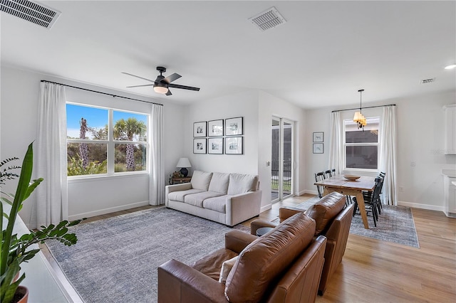 living room with light wood-type flooring and ceiling fan