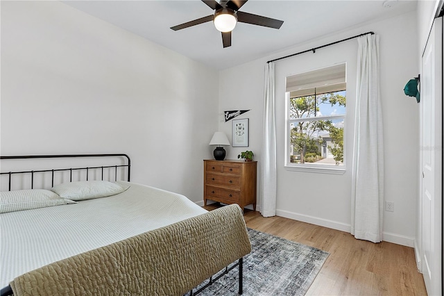 bedroom with ceiling fan and light hardwood / wood-style flooring