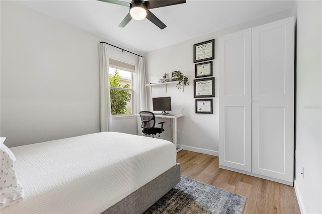 bedroom with light hardwood / wood-style flooring and ceiling fan