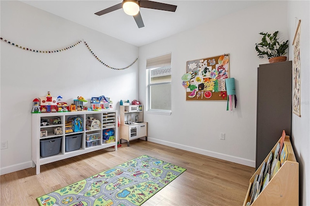 rec room featuring ceiling fan and light hardwood / wood-style floors