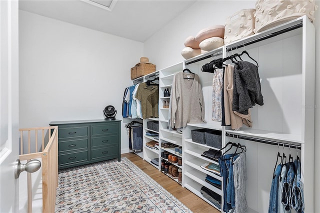 spacious closet with light hardwood / wood-style flooring