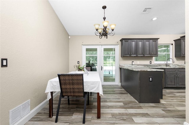 3159 Draper Ter, North Port, FL 34286 - kitchen with a chandelier, plenty of natural light, light wood-style floors, hanging light fixtures, and recessed lighting