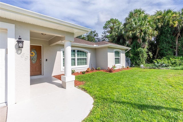 3159 Draper Ter, North Port, FL 34286 - entrance to property with stucco siding, a lawn, and a shingled roof