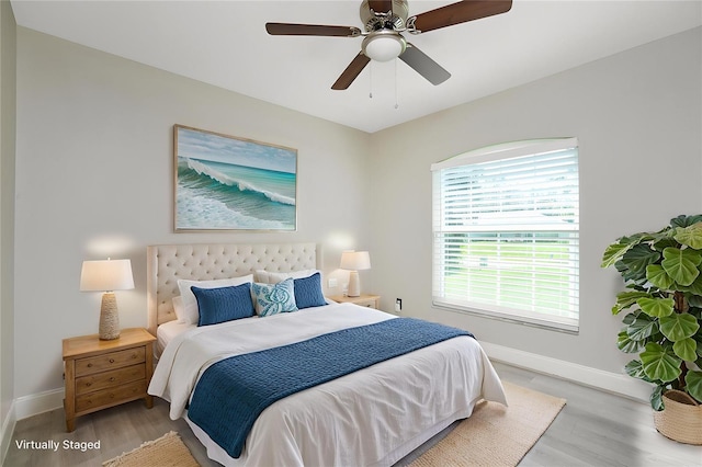 3159 Draper Ter, North Port, FL 34286 - bedroom featuring baseboards, wood finished floors, and a ceiling fan