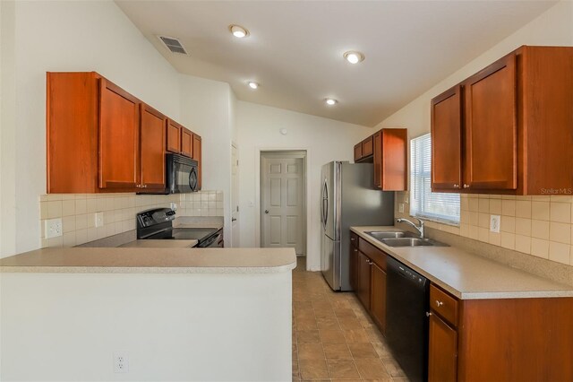 kitchen featuring black appliances, vaulted ceiling, decorative backsplash, and sink