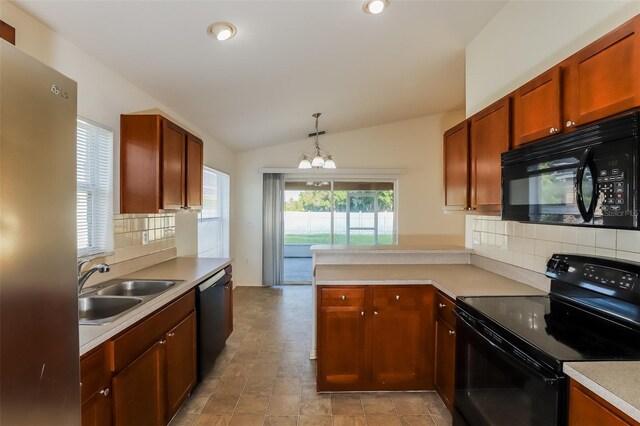 kitchen featuring vaulted ceiling, black appliances, a notable chandelier, backsplash, and sink