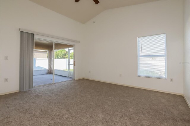 spare room featuring lofted ceiling, ceiling fan, and carpet