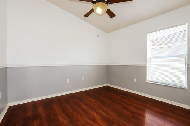 empty room with lofted ceiling, hardwood / wood-style floors, and ceiling fan