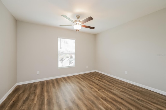 unfurnished room with dark hardwood / wood-style flooring and ceiling fan