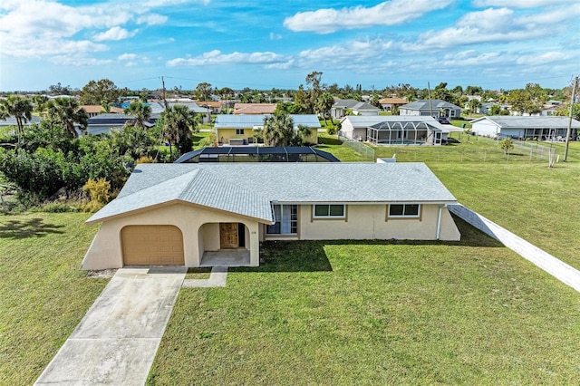 single story home featuring a garage and a front yard