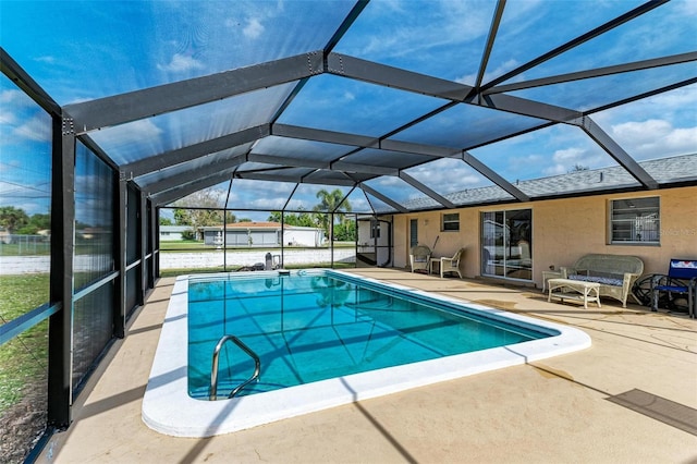 view of pool with a lanai and a patio area