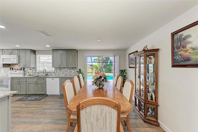 dining room with wood-type flooring and sink